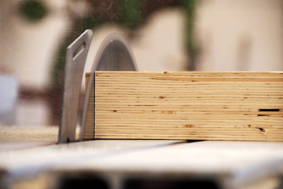 Macro picture of a piece of wood being cut by a circular saw