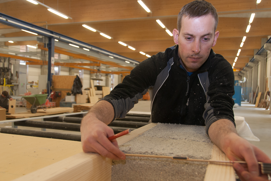 Roman measuring the distance of between two wooden boards