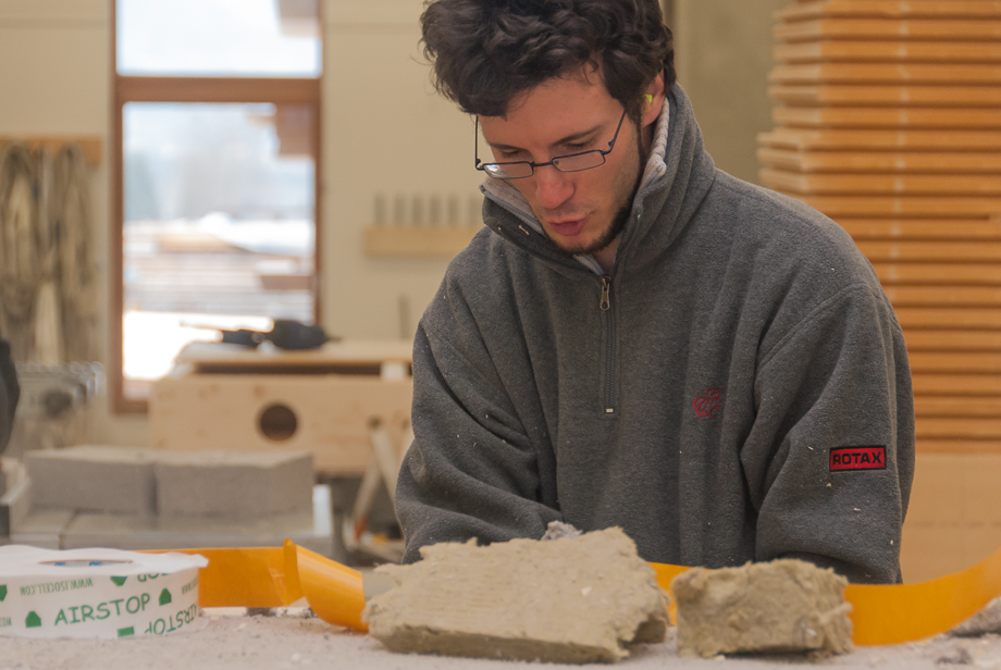 Philipp placing insulation between two wood boards