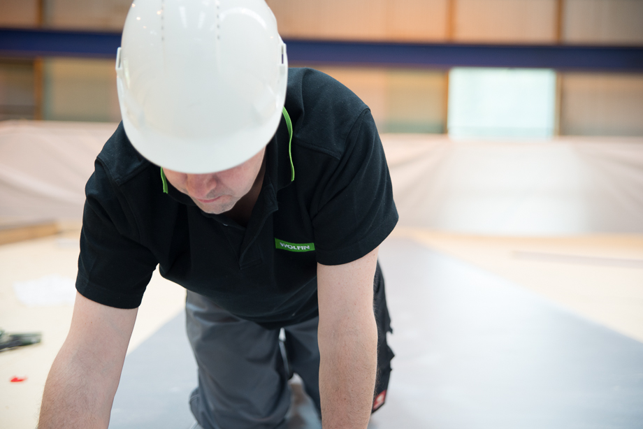 Wolfin Employee working on the insulation