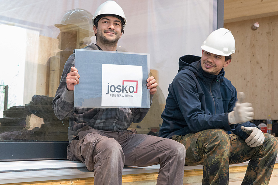 Johannes holding up a Josko Logo. He seems happy