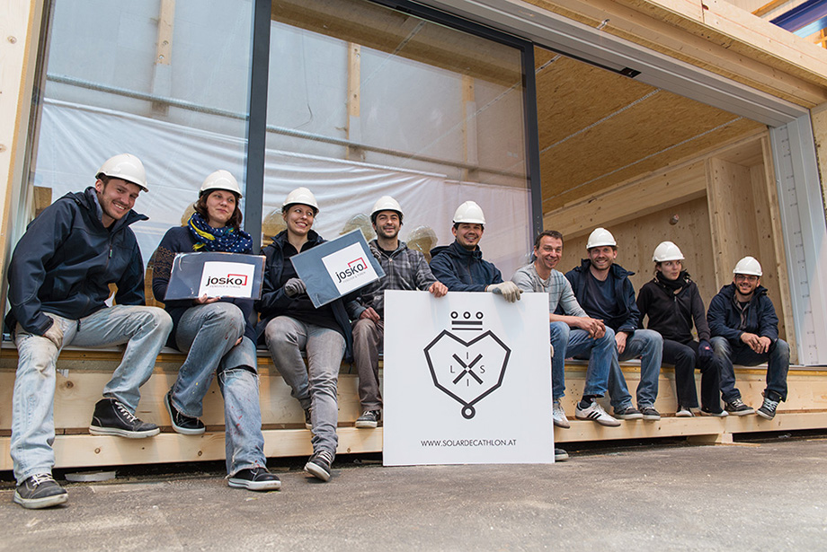 The entire team posing in front of the newly installed windows. A job well done