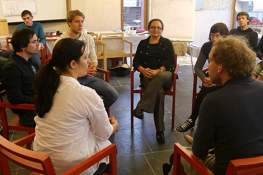 Students and teachers sit together to discuss current issues within the project