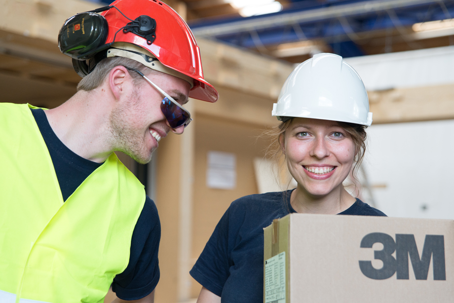 Phil and Edith smiling while wearing the helmets from company 3M