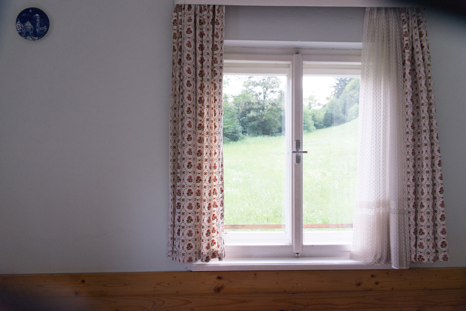 window of a rural house with vintage curtains