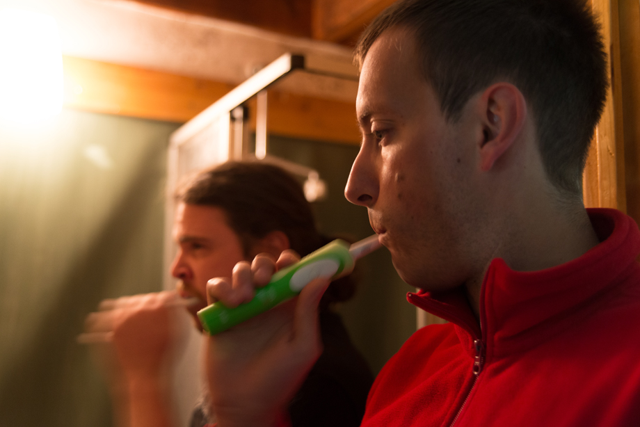 two Decathletes brushing their teeth in a tiny bathroom