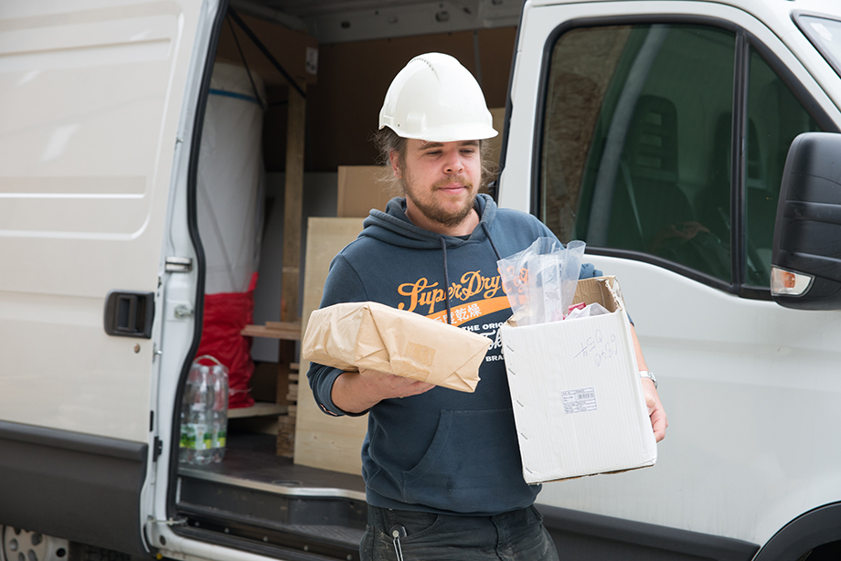 Bene carrying some materials from a truck