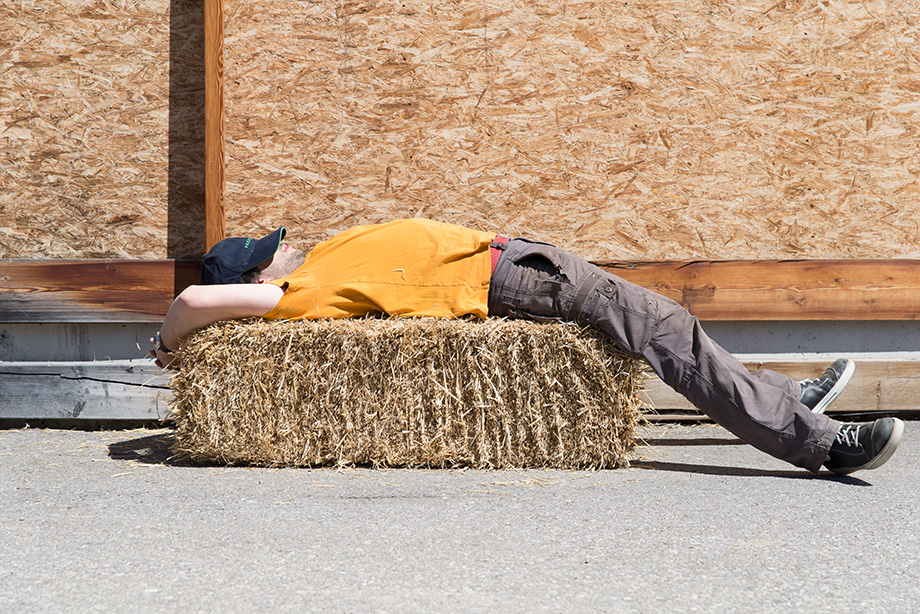 Decathlete sleeping on a stack of hay