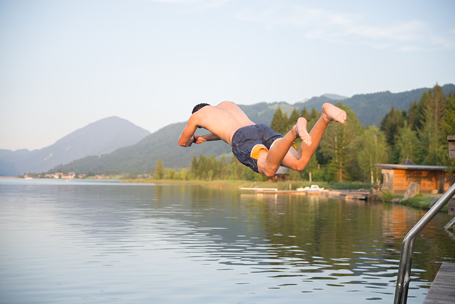 Decathlete jumping in the lake