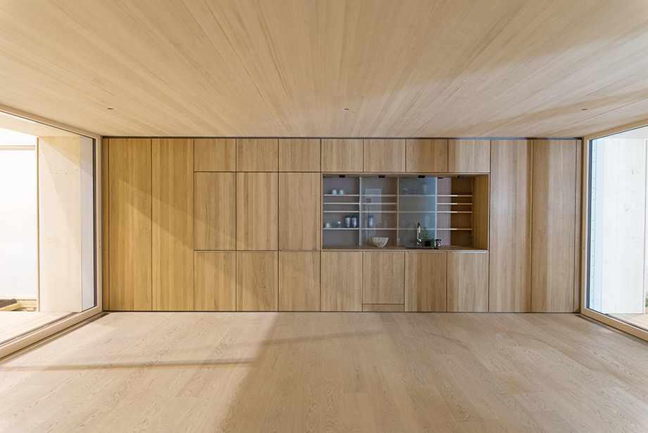 Full frontal view of the kitchen core. On the left are washing machine and dryer. On the right is the wardrobe.