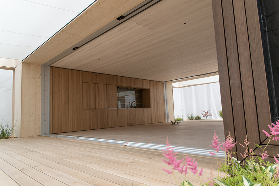 Nice view of LISI's living/kitchen space. Some pink flowers in the foreground.