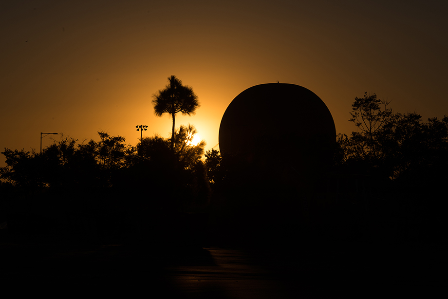 A beautiful sunset with the silhouette of palm trees and the hot air balloon.