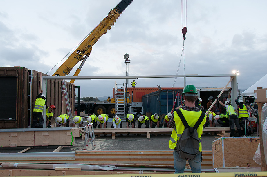 Lifting the window frame into place.