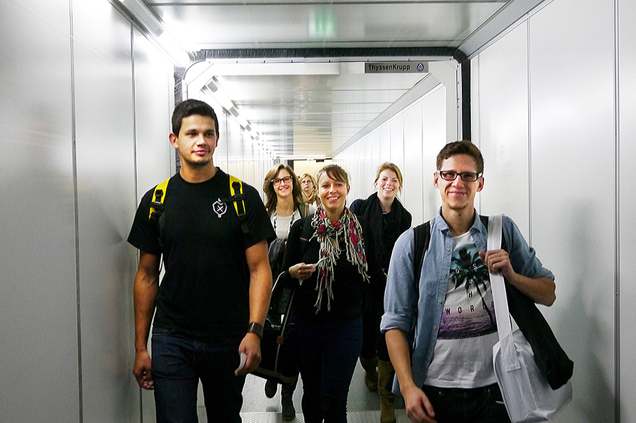 5 decathletes walking down a passenger bridge towards an airplane