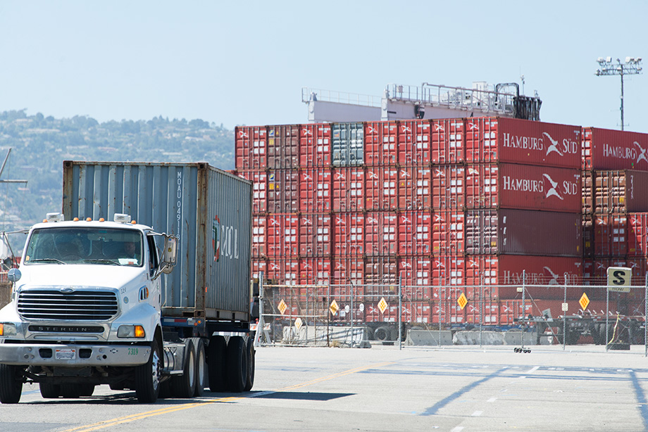 Passing by a truck loaded with shipping containers.