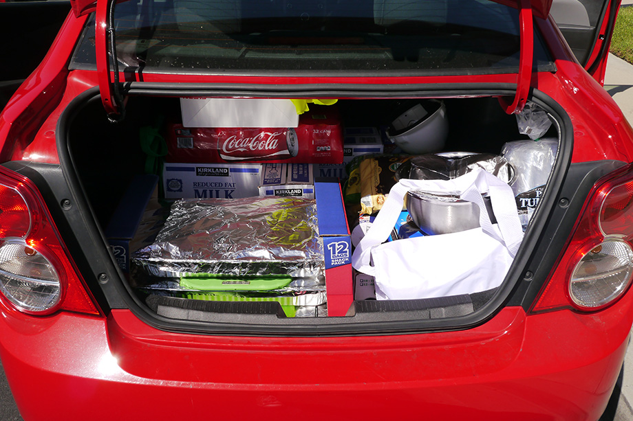 Filling the cars trunk with delicious food.