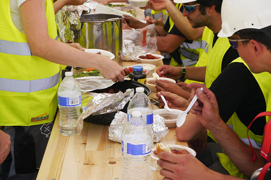 Placing the food on the table at the construction site.