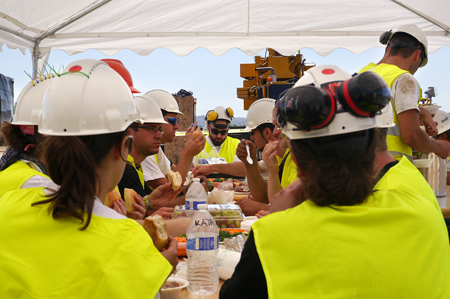 Lots of people sitting at a table eating.