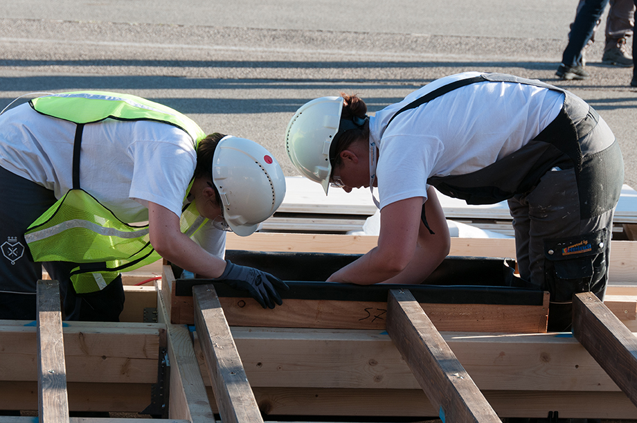 Two decathletes working on the terrace decking.