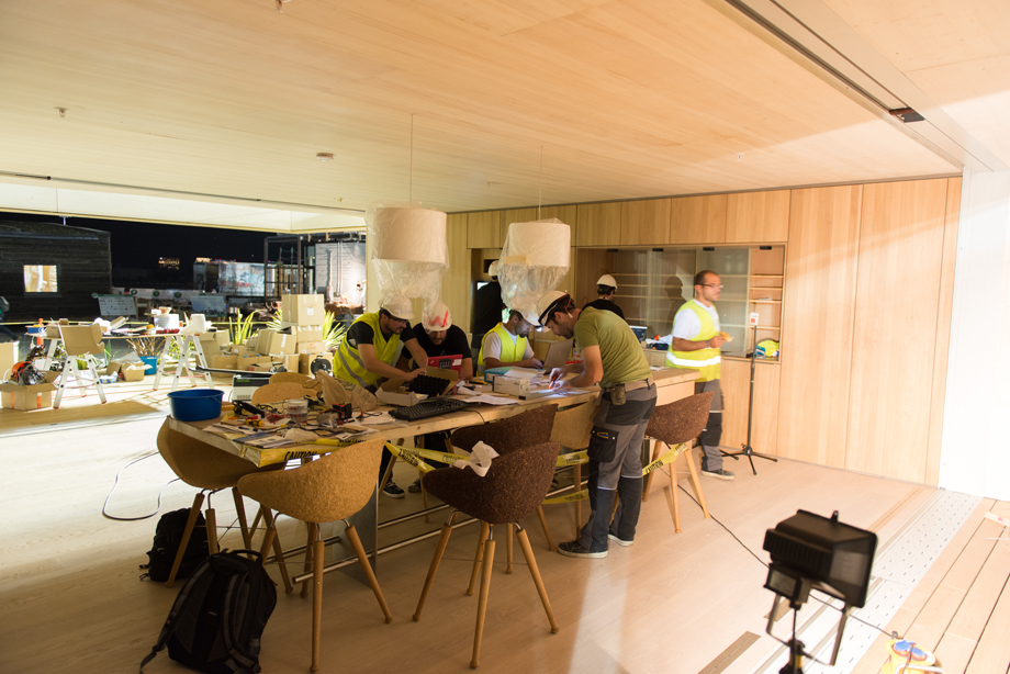 The lamps above the dining table are hanging. The interior is starting to take on form.