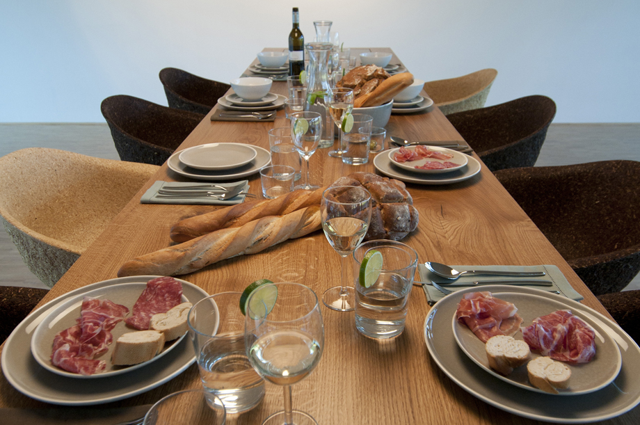 A table full with food. Bread and prosciutto.