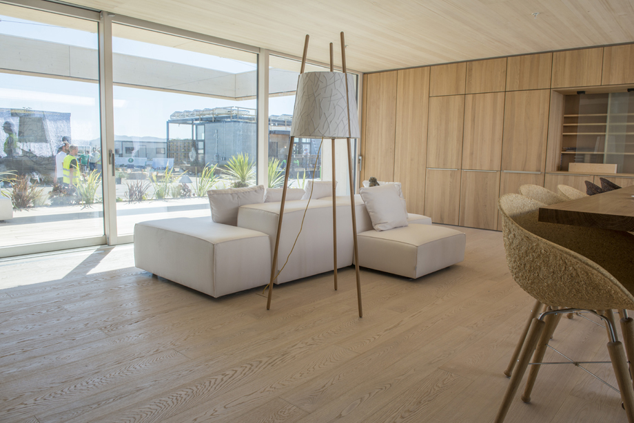 In the background, the white couch. In the foreground, the standing lamp.