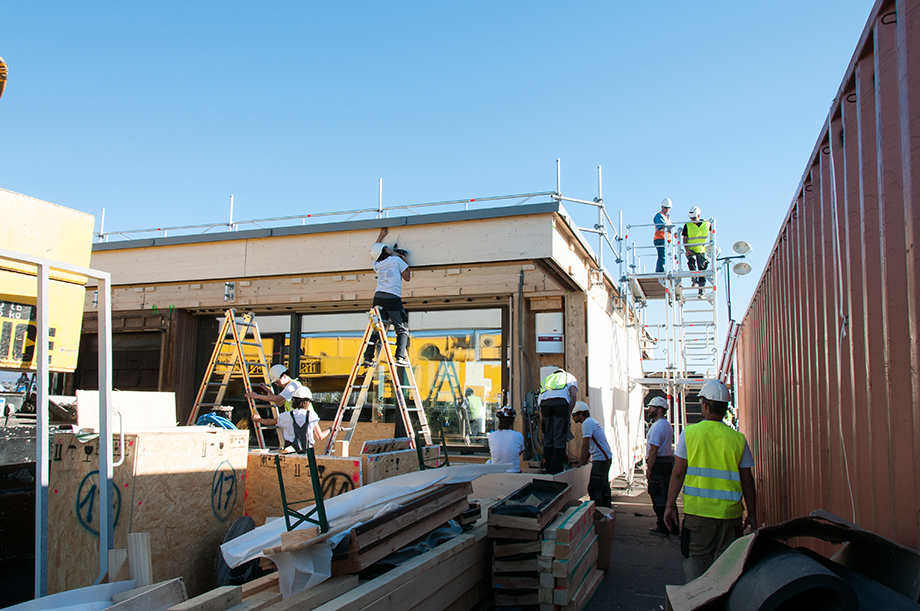 Picture of the exterior. A student standing on the ladder.