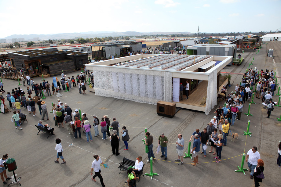 Visitors line up to tour the Team Austria house, built by students from Vienna Institute of Technology, after it came in first place overall at the U.S. Department of Energy Solar Decathlon 2013 at the Orange County Great Park in Irvine, Calif. on October 13, 2013 (Credit: Stefano Paltera/U.S. Department of Energy Solar Decathlon)