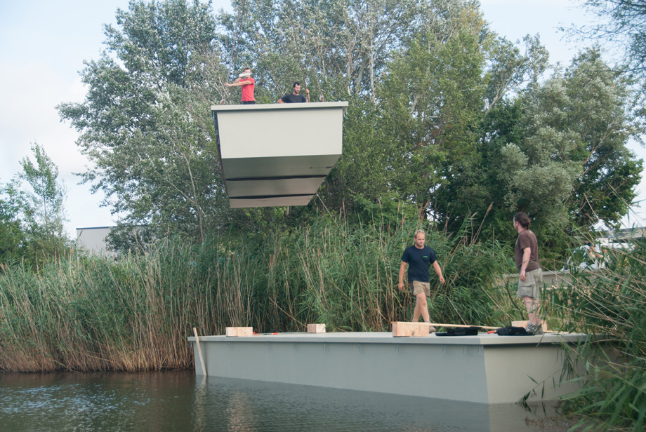 Another pontoon is lifted and gliding over the water.