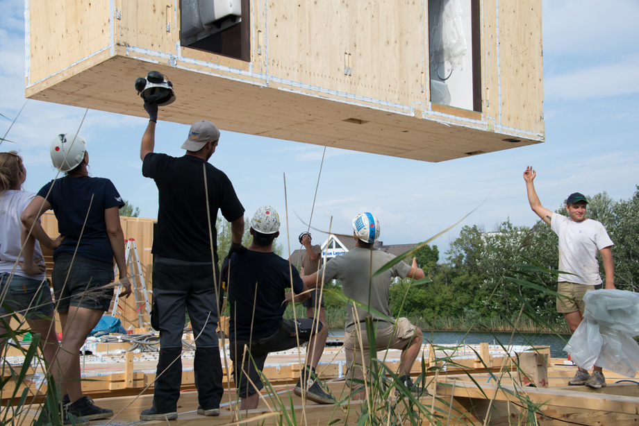 The bathroom core is also lifted onto the wooden pontoons. Decathletes gather and hope it wont sink.