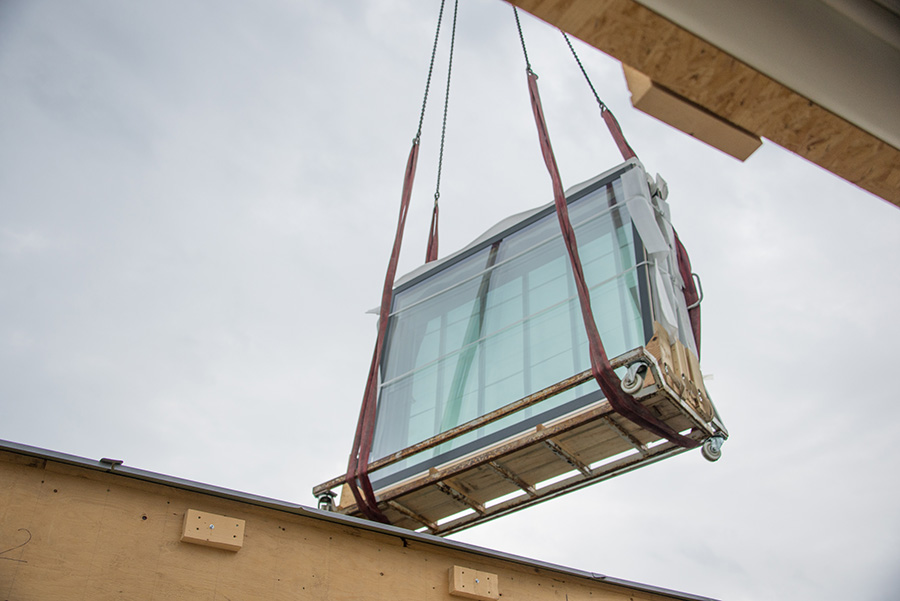 Windows are being lifted with a crane.