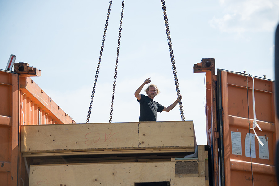 The first roof module is being lifted from the container. 8 long months.