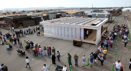 Visitors line up to tour the Team Austria house, built by students from Vienna Institute of Technology, after it came in first place overall at the U.S. Department of Energy Solar Decathlon 2013 at the Orange County Great Park in Irvine, Calif. on October 13, 2013 (Credit: Stefano Paltera/U.S. Department of Energy Solar Decathlon)