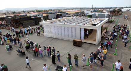 Visitors line up to tour the Team Austria house, built by students from Vienna Institute of Technology, after it came in first place overall at the U.S. Department of Energy Solar Decathlon 2013 at the Orange County Great Park in Irvine, Calif. on October 13, 2013 (Credit: Stefano Paltera/U.S. Department of Energy Solar Decathlon)